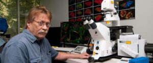 Photo of Michael Davidson at a microscope